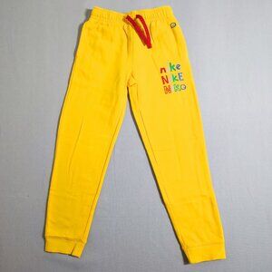 Nike Jogger pants men's youth size M yellow colour with multi-colour graphic